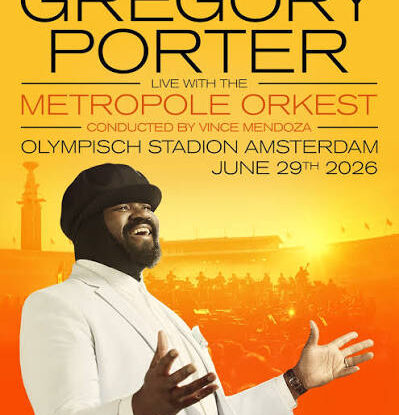 Promotional poster for Gregory Porter with the Metropole Orkest, conducted by Vince Mendoza, performing at Olympisch Stadion Amsterdam on June 29, 2026; Porter wearing a white suit with arms open against an orange sunset background.